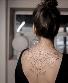 a woman with a tattoo on her back