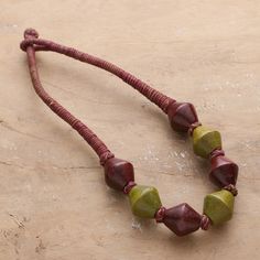 Brown and green hues invite you to express your bohemian spirit through nature-inspired details. Presented by India's Rahul Jain, this haldu wood beaded necklace features stylish geometric pendants that create a chic vibe around the piece, also accented with a comfortable cotton cord in green and burgundy colors. Bone Bead Necklace, Green And Burgundy, Hand Painted Necklace, Brown Jewelry, Wood Bead Necklace, Hand Painted Jewelry, Brown And Green, Green Hues, Brass Decor