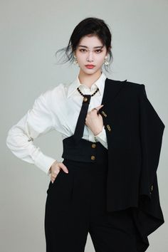 a woman wearing a black suit and white shirt