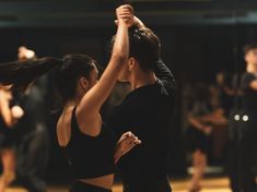 two people are dancing in a dance class