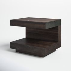 a wooden table with two sections stacked on top of each other, one section is black and the other part is brown