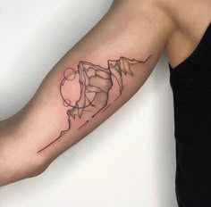 a woman's arm with a tattoo on it that has mountains in the background