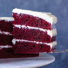 a slice of red velvet cake with white frosting