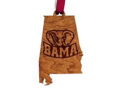 a wooden state shaped ornament with the word obama on it's side