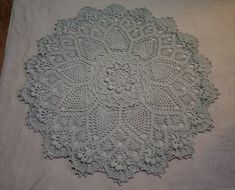 a white doily is laying on top of a table