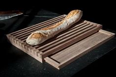 a loaf of bread sitting on top of a wooden cutting board