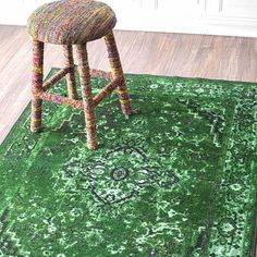 a chair sitting on top of a green rug