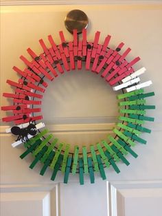 a wreath made out of clothes pegs on the front door