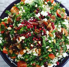 a blue plate topped with salad and lots of toppings