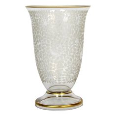 a glass vase with gold trimmings on the bottom and sides, sitting on a white background