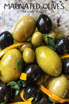 olives and yellow peppers are piled on top of each other with the words marinated olives above them