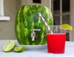 a watermelon with a drink in front of it