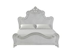 a white bed with an ornate headboard and foot board