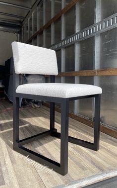 a white chair sitting on top of a wooden floor