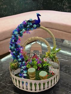 a basket filled with flowers and plants on top of a table