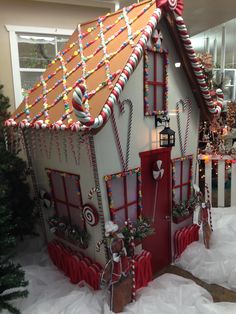 a gingerbread house is decorated with candy canes