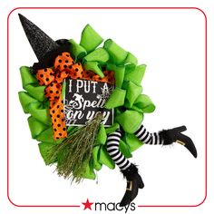 a green wreath with black and white striped stockings, witch's hat and polka dots