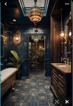 a bathroom with blue tiles and gold fixtures on the walls, along with a bathtub