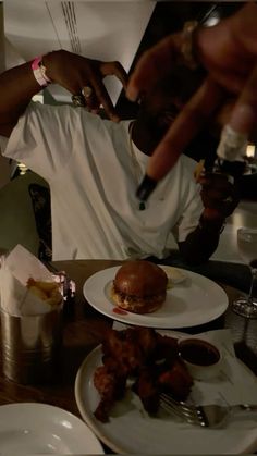 a man sitting at a table with plates of food