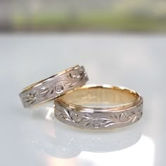 two wedding rings sitting on top of a table