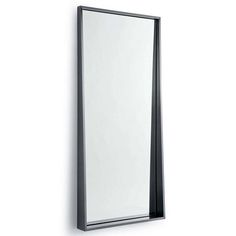 a mirror mounted to the side of a wall next to a white wall with a black frame