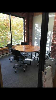 an empty conference room with a table and chairs