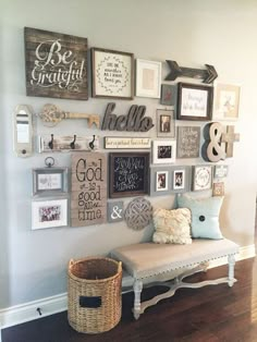 a white bench sitting in front of a wall filled with pictures and framed art on it