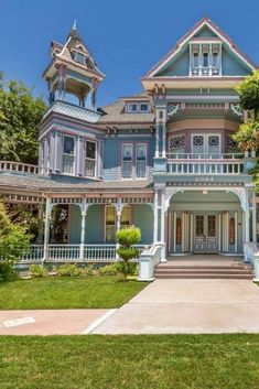 a large blue and white house with lots of windows