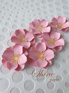 pink paper flowers with gold centers on white polka doted card stocking, ready to be cut and embellished