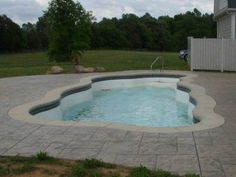 an empty swimming pool in the middle of a yard