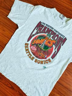 Vintage Seattle Sonics NBA Finals 90's Shirt Cheap Jersey College T-shirt, Cheap Pop Culture Graphic T-shirt, Cheap 90s Style Sports T-shirt, Cheap 90s Sports T-shirt, Vintage Mlb Shirt, Graphic Tee Design Prints Retro Vintage, Vintage Nba Shirt, Vintage Nfl Shirts, 90s Style Tops For Game Day During Sports Season