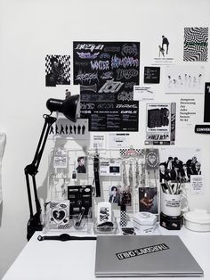 a white desk topped with lots of black and white items