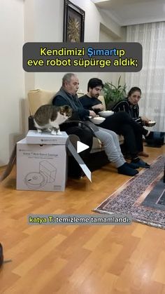 a group of people sitting on couches in a living room next to a cat