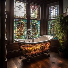 a bath tub sitting in front of two stained glass windows next to a potted plant