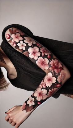 a woman's arm with flowers on it, and her legs covered in tattoos