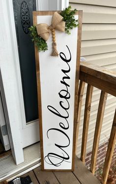 Welcome! :) This listing is for my handmade Front Porch Leaner that reads, "Welcome" The porch sign is fully stained in front & back, painted, sealed & then topped with an adorable bow & greenery! This porch leaner is great for a year-round modern farmhouse vibe! It also would make a fun & easy gift for family and friends! - This sign is about 4ft tall and 11.75 inches wide. - Stained in Aged Wood OR light brown Early American. (not pictured) but is a light brown. - Painted in Acrylic black - Ri House Number Signs Front Porches, Diy Welcome Sign Wood Front Porches, Door Leaner Signs, Front Porch Signs Wooden Diy, Porch Boards Signs, Diy Welcome Sign Wood, Small Front Porch Ideas Entrance, Welcome Signs For Front Door, Welcome Porch Leaner