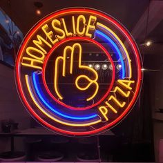 a neon sign that says home slice pizza