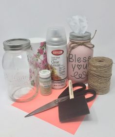 some craft supplies are sitting on top of a piece of pink paper and twine