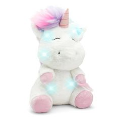 a white stuffed unicorn with pink and blue lights on its head sitting in front of a white background