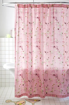 a pink shower curtain with flowers on it