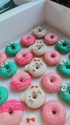 a box full of hello kitty donuts with frosting and sprinkles