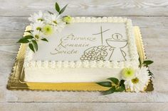 a cake decorated with flowers on top of a wooden table