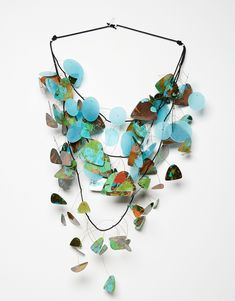 Mixed-Media Necklace - Takara Beatheagudell continues her exploration of artistic expression through color, texture, and complex designs with this airy statement piece. Multicolored shapes of laser-cut paper, each sealed with a poly resin, seem to float above the elastic cording due to the artists use of hand-knotted monofilament.<b><br> Necklace is 47, can be shortened to 40 with adjustable barrel clasp closure. Artful Home Jewelry, Resin Necklaces, Colorful Jewelry Aesthetic, Mixed Media Necklace, Laser Cut Paper, Vintage Paper Background, Laser Cut Jewelry, American Jewelry, Polymer Crafts