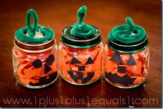 two glass jars with halloween decorations in them