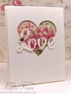 a white card with pink flowers and the word love written in cursive writing