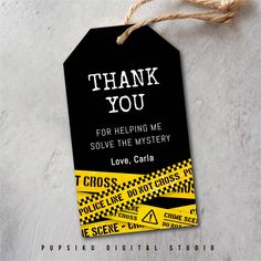 a black tag with yellow and black caution tape on it that says thank you for helping me solve the mystery