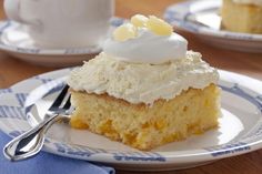 a piece of cake sitting on top of a white plate next to a cup of coffee