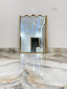 a bathroom mirror sitting on top of a marble floor