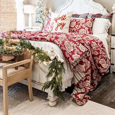 a bedroom decorated for christmas with red and white bedding