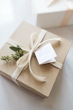 a gift wrapped in brown paper and tied with a white ribbon